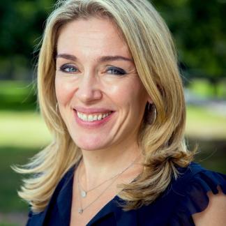 Portrait of Abigail Marsh smiling in a sunny outdoor setting