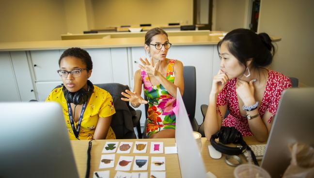 Photo of Delphine Dahan working on a study with two students